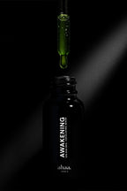 AHA BHA exfoliating serum bottle on black background
