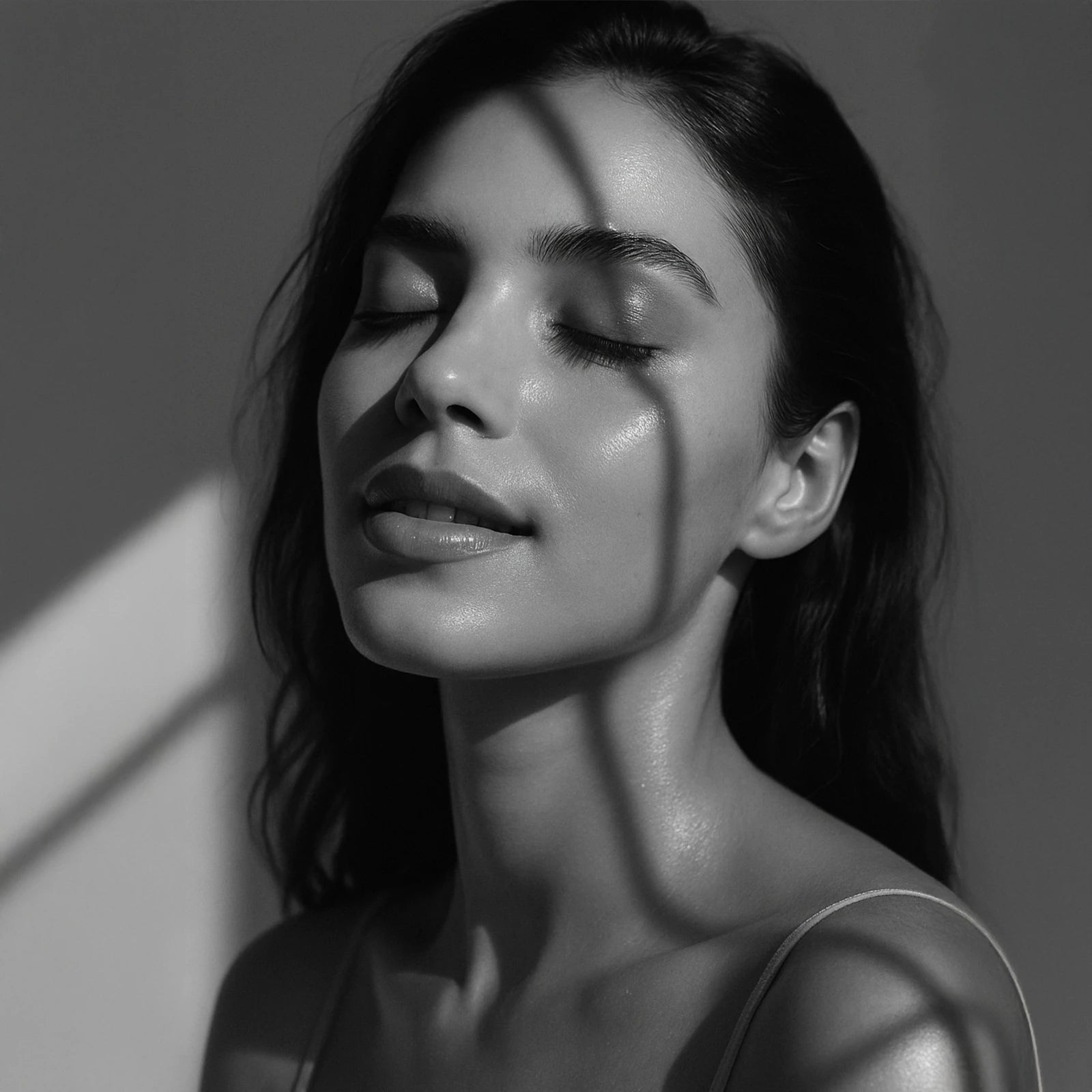 Close-up portrait of a woman sensing the Ahaa® Skincare moment as the product melts into her skin, capturing the intimate feeling of clarity and ritual.