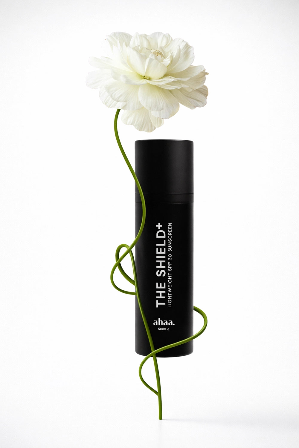 The Shield+ lightweight sunscreen with a white flower on a white background